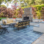 outdoor fireplace installation Des Moines custom stone patio seating walls by Escape Landscaping