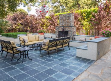 outdoor fireplace installation Des Moines custom stone patio seating walls by Escape Landscaping